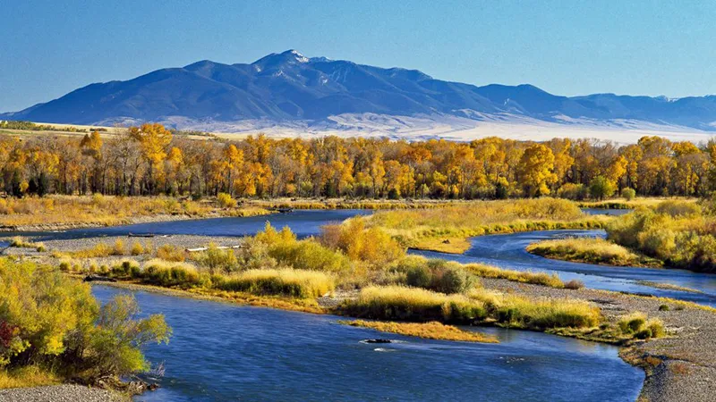 Fishing boats and fly fishers on the Missouri River in Craig, Montana